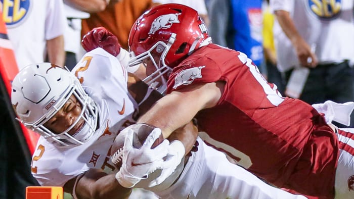 Razorbacks linebacker Bumper Pool makes a tackle against Texas in 2021